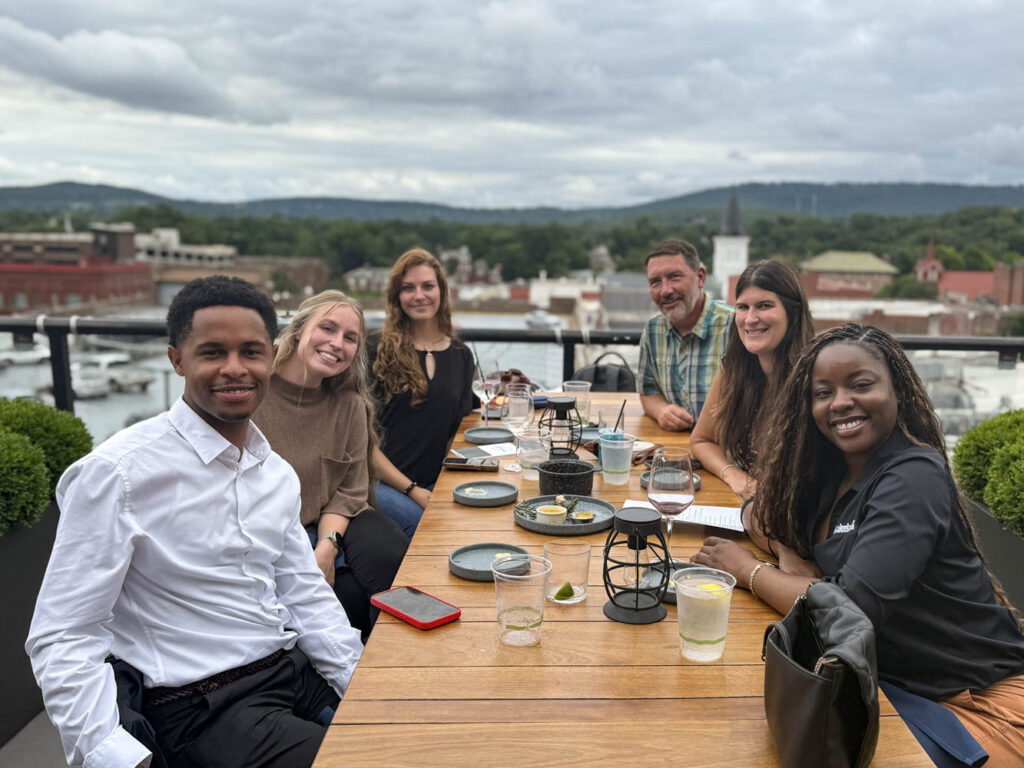 Group dining outdoors with scenic background