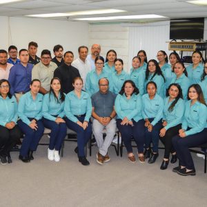 Office team group photo in work setting.