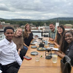 Group dining outdoors with scenic background