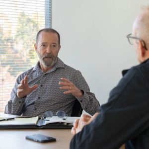 Two men discussing business at a table.